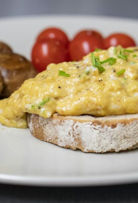 Creamy scrambled eggs on toast with chives