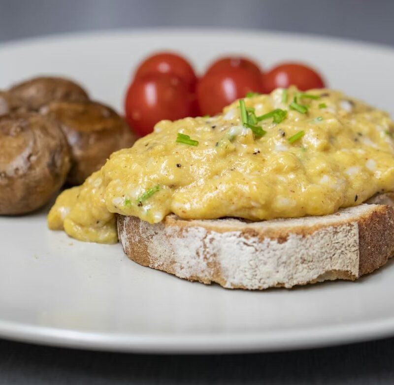 Creamy scrambled eggs on toast with chives