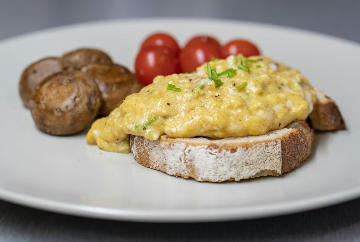 Creamy scrambled eggs on toast with chives