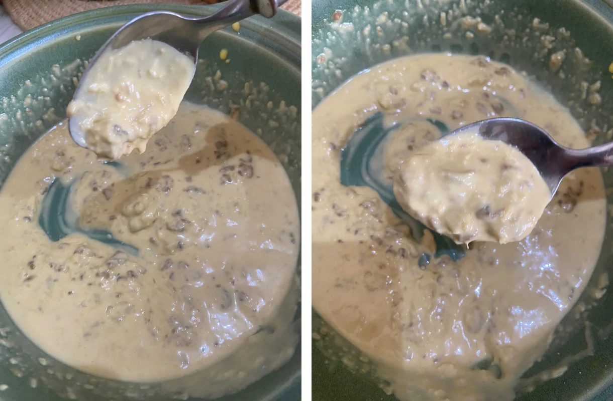 Homemade caesar salad dressing thick on a spoon, egg yolk and anchovy emulsion with visible anchovy pieces