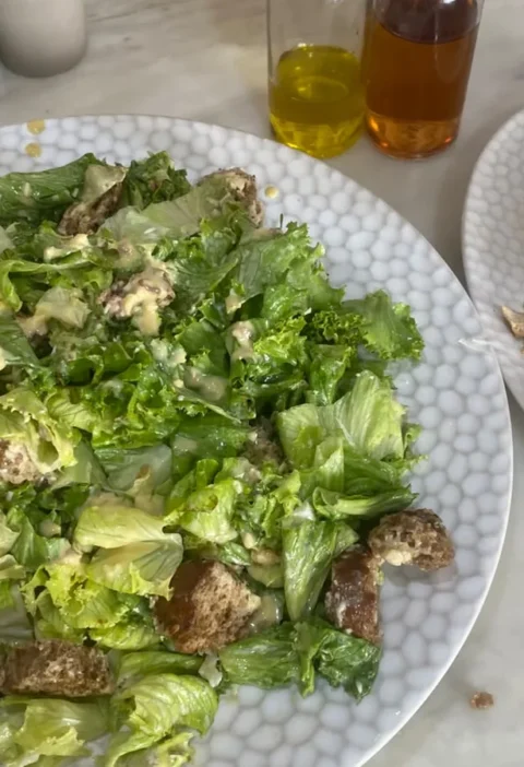 Gordon Ramsay caesar salad with Parmesan croutons and homemade anchovy dressing, griddled chicken and lemon served alongside